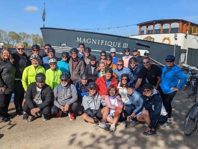 Group of Cyclists with Ship Magnifique