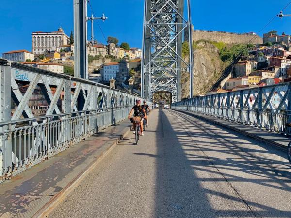 Cycling over a bridge in Porto